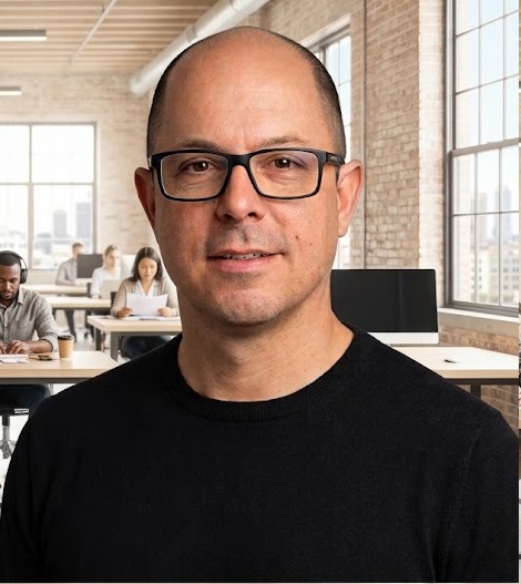 Gustavo Roland, CEO of Mabinsoft, in the office with colleagues working in the background